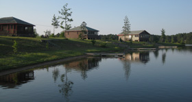 Cottages reflected in still water at evening